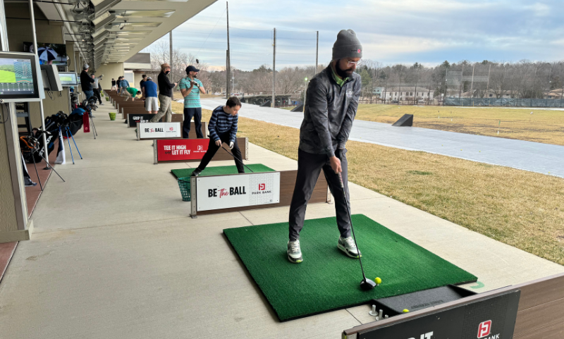 People golfing at Vitense Golfland's bays