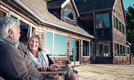 Couple smiling outside their home